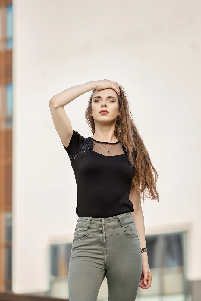 Chic Black Mesh Accent Top with Olive High-Waist Skinny Jeans